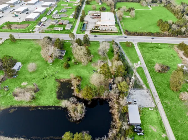 an aerial view of a house with a yard
