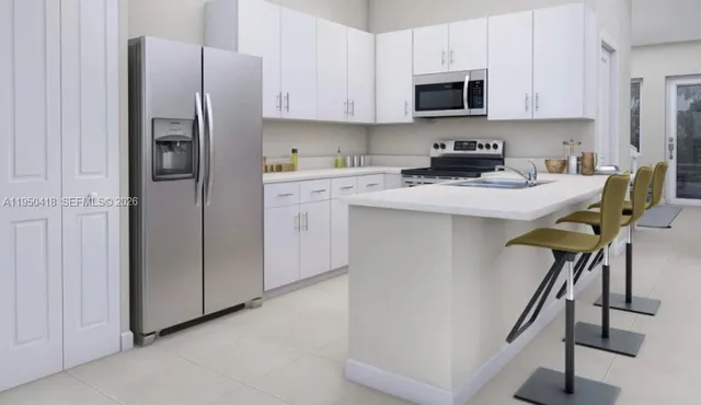 a kitchen with stainless steel appliances a refrigerator and a stove top oven