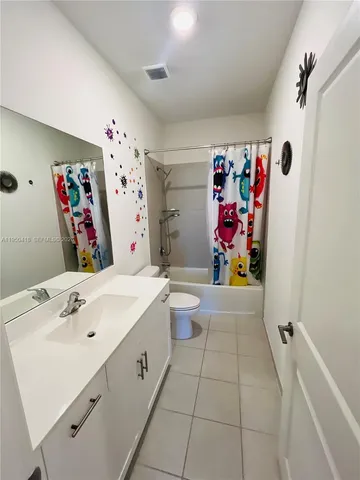 a bathroom with a sink mirror vanity and toilet