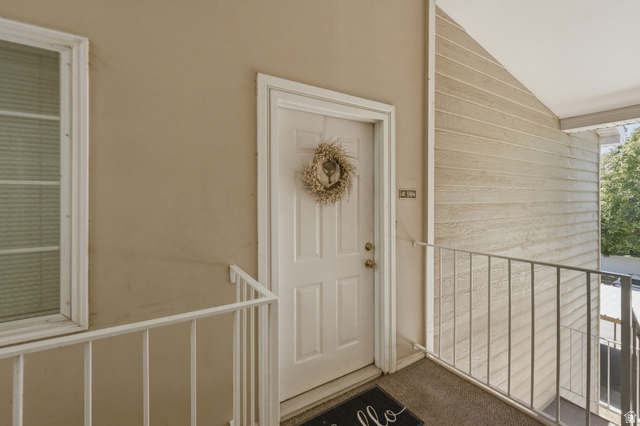 650 South Main Street, Unit 3304 Bountiful, UT 84010 - Photo 2 of 22 Entryway featuring a white paneled door, light-toned exterior walls, and a white framed window