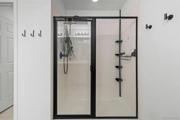 a bathroom with a glass shower door