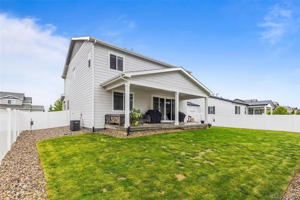 a front view of house with deck and outdoor seating