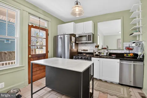a kitchen with stainless steel appliances a refrigerator sink and stove