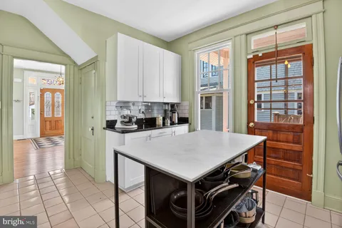 a kitchen with a table chairs and a refrigerator