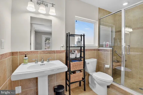 a bathroom with a sink toilet and shower