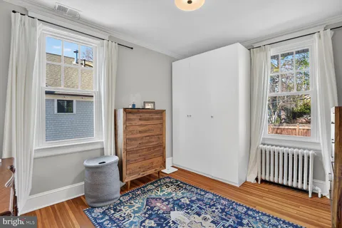 a view of an empty room with a birdcage and a window