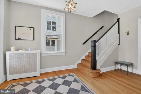 a view of a livingroom with wooden floor and stairs