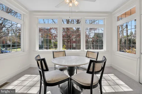 a view of a dining room with furniture large windows and wooden floor