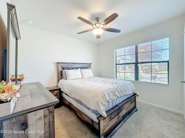 a bedroom with a large bed and a large window
