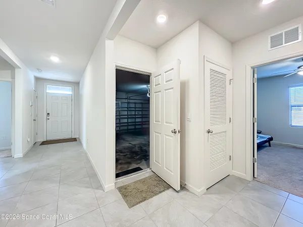 a view of a hallway to kitchen and dining room