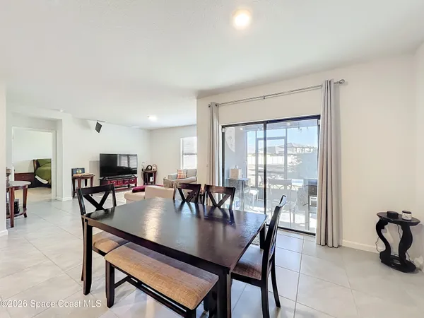 a dining room with furniture and window