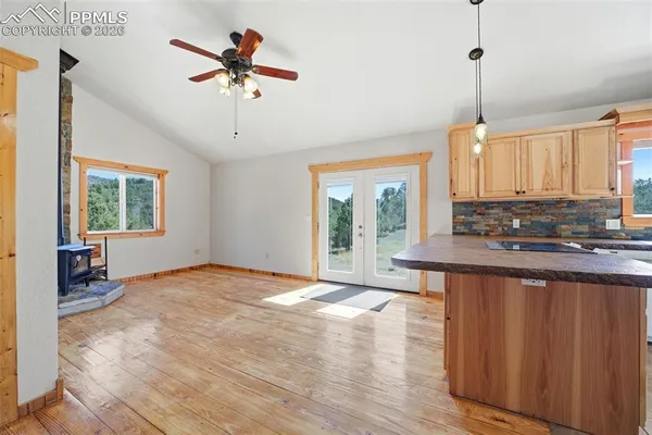a view of kitchen with granite countertop cabinets and wooden floor
