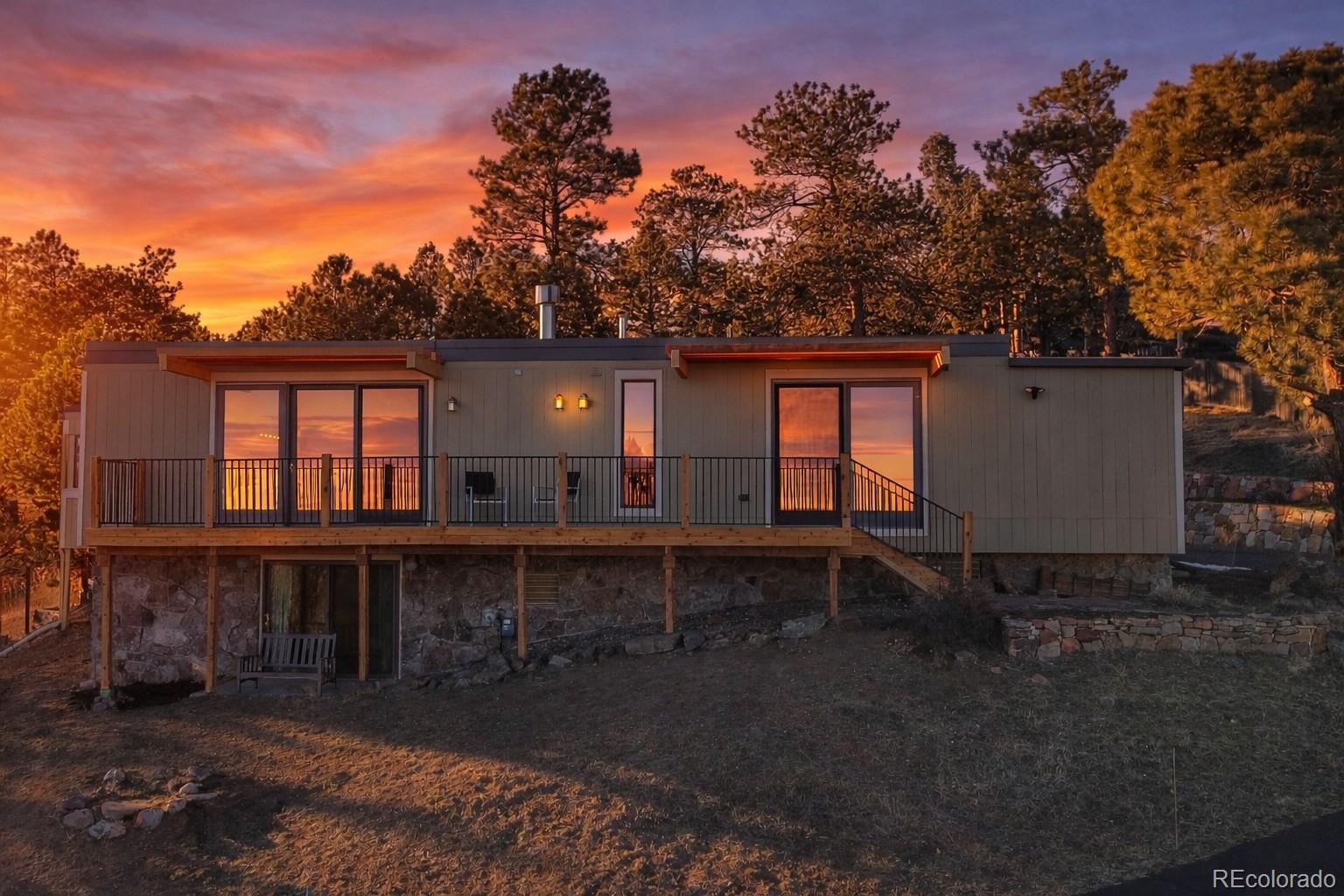 243 Paradise Road Golden, CO 80401 - Photo 1 of 49 a backyard of a house with barbeque oven and outdoor seating