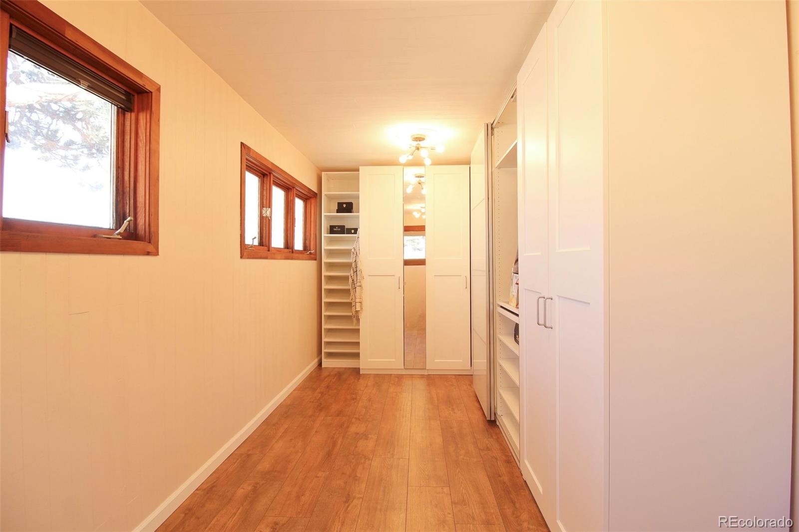 243 Paradise Road Golden, CO 80401 - Photo 22 of 49 a view of a hallway with wooden floor and a bathroom
