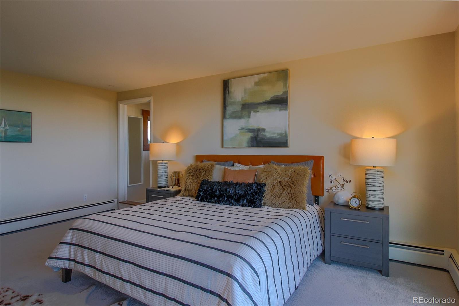 243 Paradise Road Golden, CO 80401 - Photo 3 of 49 a bedroom with a bed and a night stand