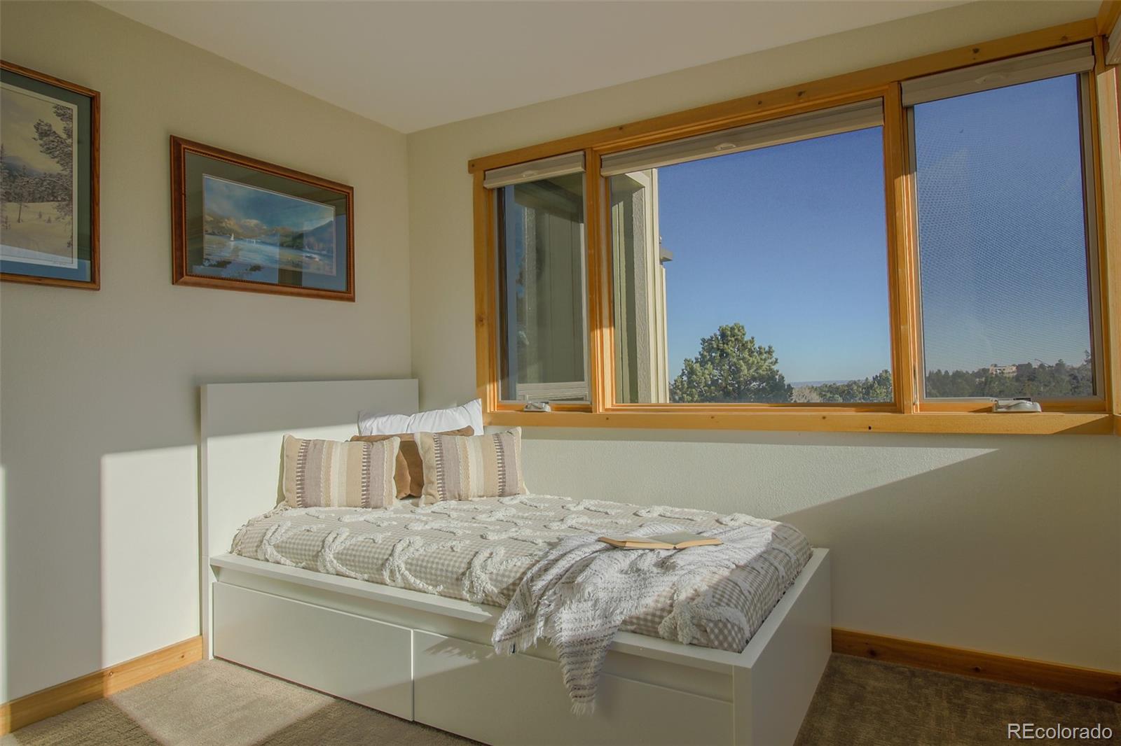 243 Paradise Road Golden, CO 80401 - Photo 34 of 49 a bedroom with a bed and a window