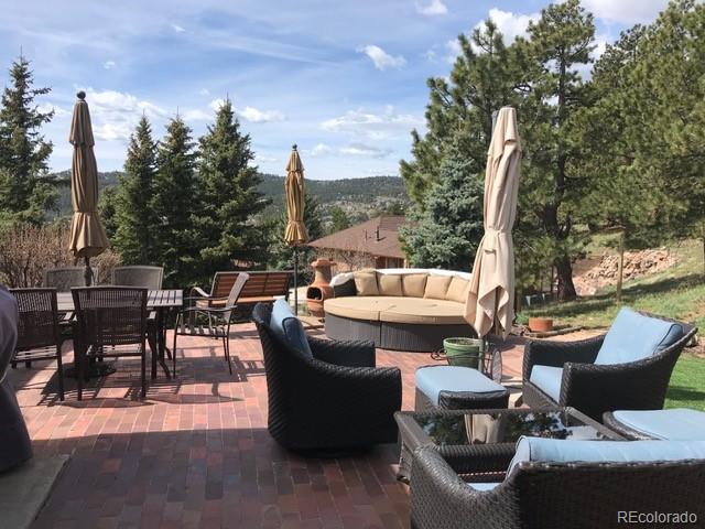 243 Paradise Road Golden, CO 80401 - Photo 41 of 49 a view of a patio with couches chairs and a table