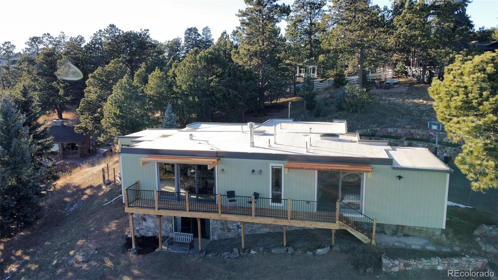 243 Paradise Road Golden, CO 80401 - Photo 42 of 49 a view of a cafe with table and chairs with wooden fence and plants