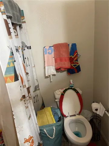 a bathroom with a toilet mirror and tub