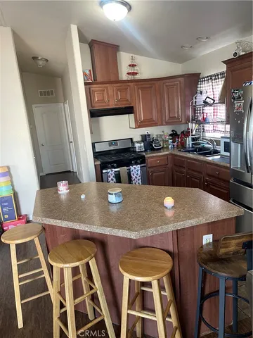 a kitchen with stainless steel appliances and dining table