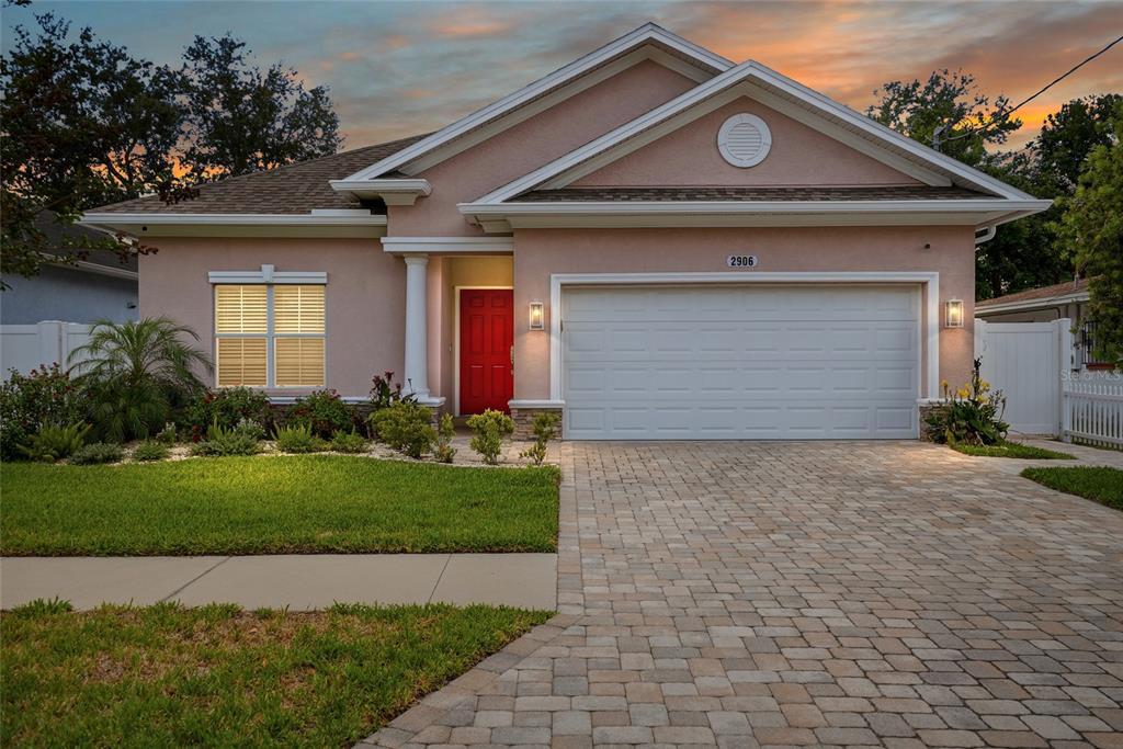 2906 West Douglas Street Tampa, FL 33607 - Photo 1 of 36 a front view of a house with a yard and garage