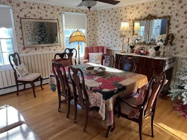 a view of a dining room with furniture and chandelier
