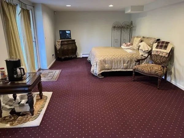 a bedroom with furniture and a window