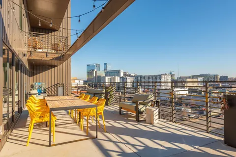 a view of a patio with table and chairs