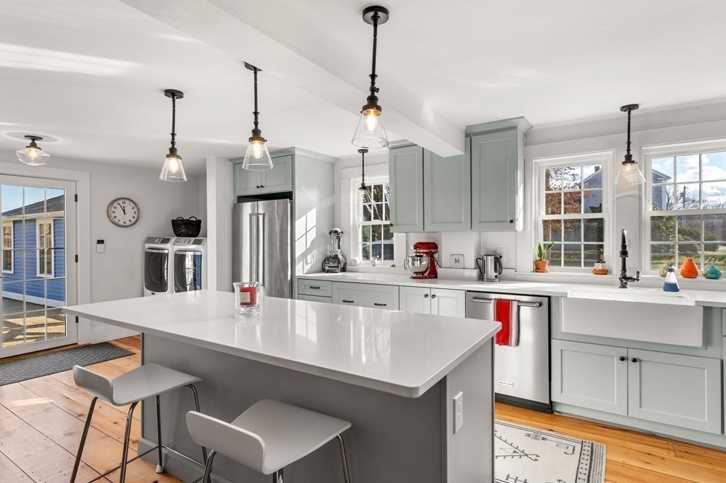 161 High Road Newbury, MA 01951 - Photo 4 of 39 a kitchen with a stove a sink dishwasher a dining table and chairs with wooden floor