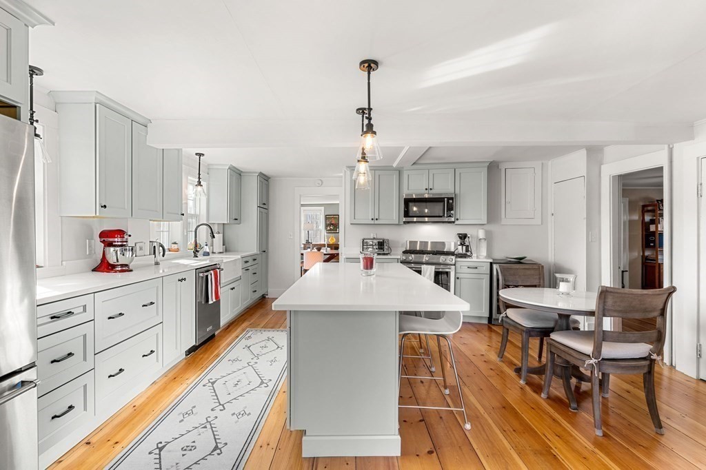 161 High Road Newbury, MA 01951 - Photo 5 of 39 a kitchen with white cabinets and stainless steel appliances