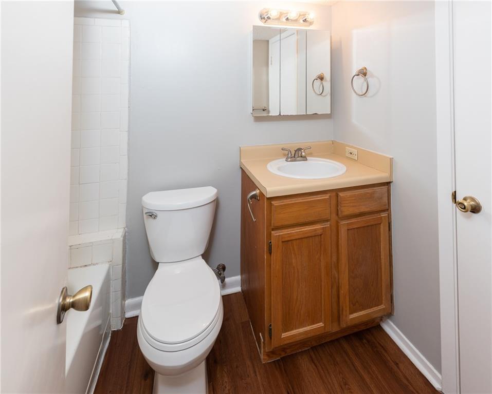 3115 Helms Street, Unit 116 Austin, TX 78705 - Photo 9 of 12 Full bath with vanity and dark wood-style floors