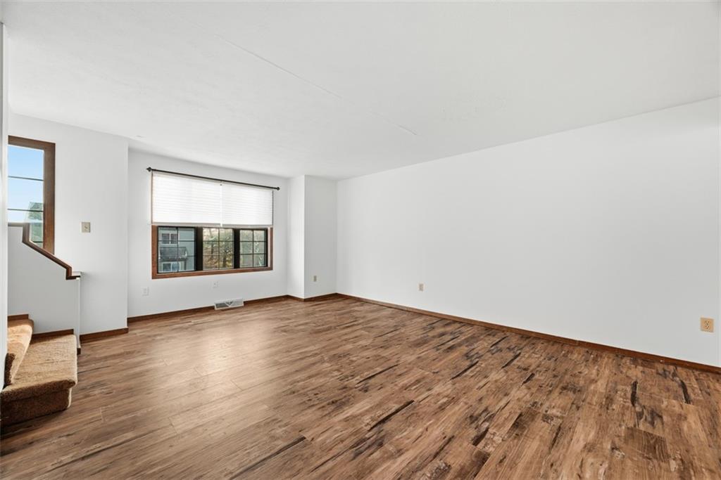 14 Bethany Drive, Unit A Pittsburgh, PA 15215 - Photo 2 of 23 an empty room with wooden floor and windows