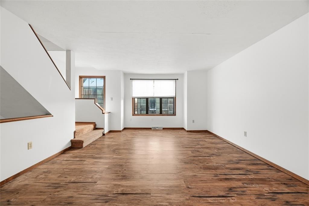 14 Bethany Drive, Unit A Pittsburgh, PA 15215 - Photo 3 of 23 a view of an empty room with a window and wooden floor