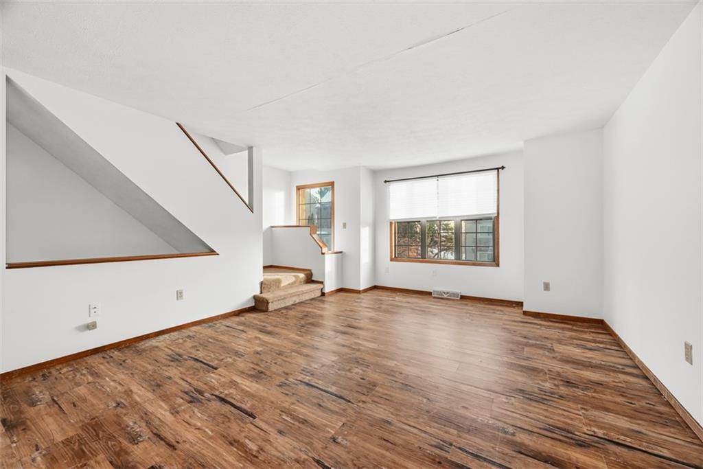 14 Bethany Drive, Unit A Pittsburgh, PA 15215 - Photo 4 of 23 a view of an empty room with wooden floor and a window