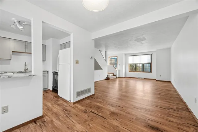 a view of a kitchen cabinets and wooden floor