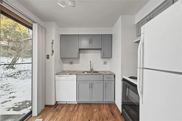 a kitchen with stainless steel appliances a stove sink and refrigerator