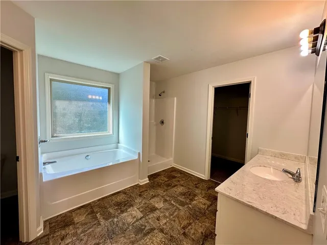 a view of an empty room and bathroom