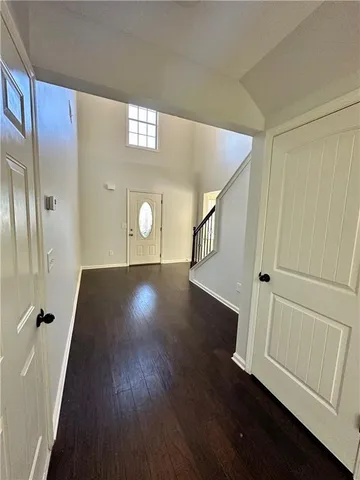 a view of a hallway with wooden floor and staircase