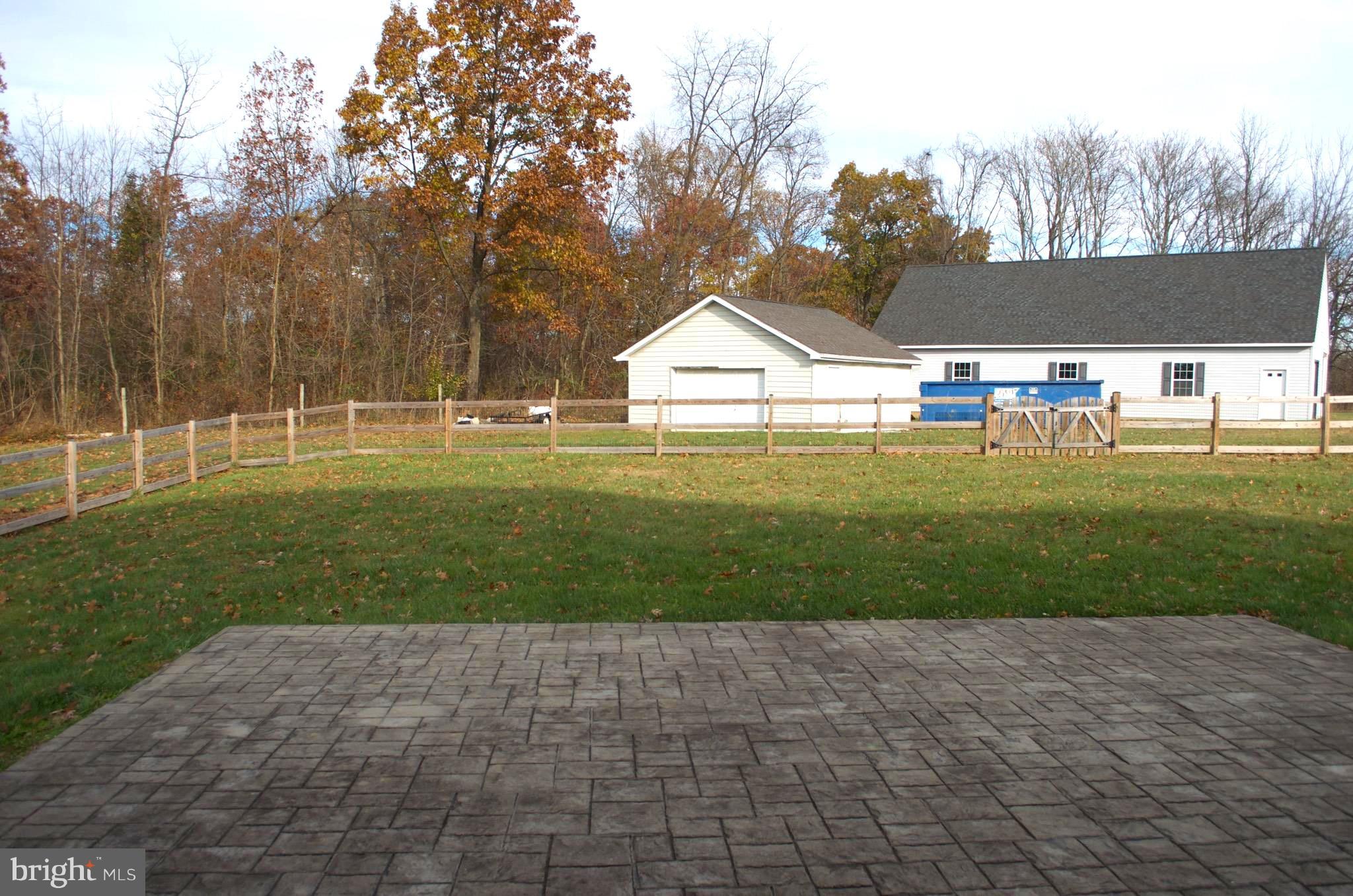 4113 Summit Point Road Charles Town, WV 25414 - Photo 3 of 27 a front view of a house with a yard and trees