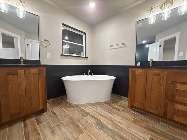 a view of a room with wooden floor and window
