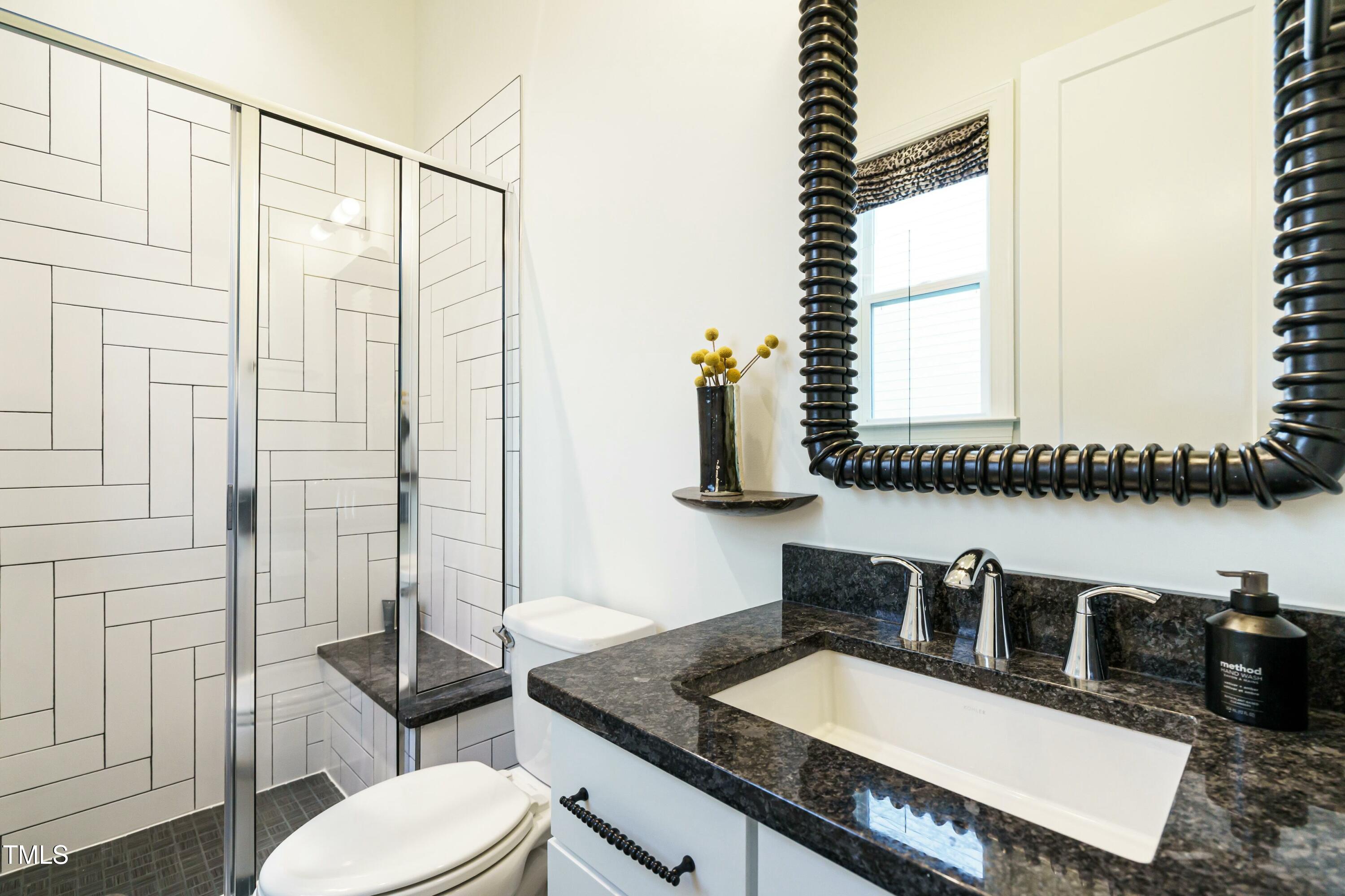 5265 Aleppo Lane Raleigh, NC 27613 - Photo 20 of 45 Note the cabinet pulls and mirror. Every space blends warmth, refinement, and playfulness in equal measure.
