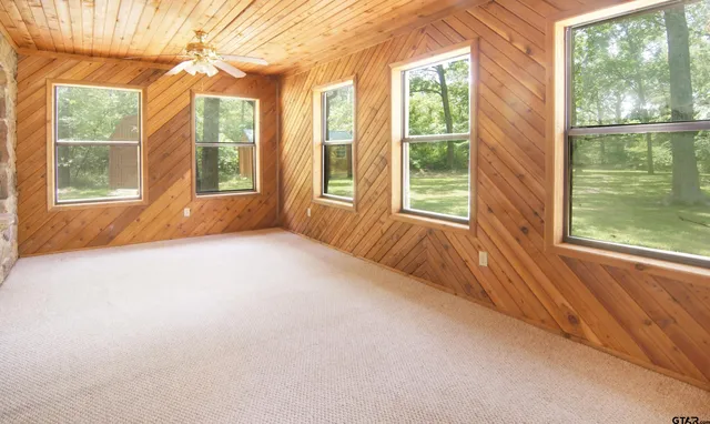 a kitchen with stainless steel appliances granite countertop a sink and a large window