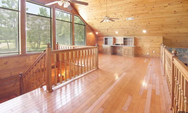 a view of a backyard with large trees