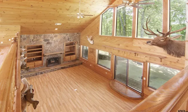 a view of a house with a large window and plants