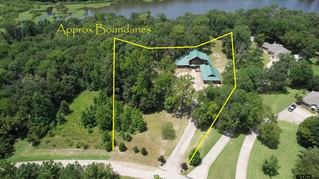 a view of a yard with a lake view