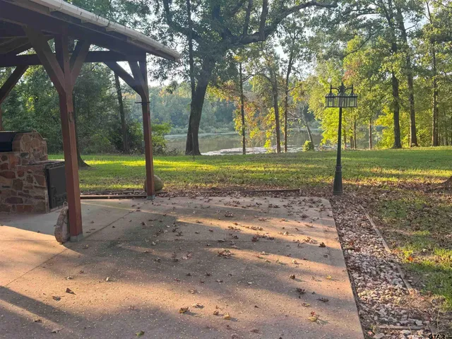 a aerial view of a house with a yard and lake view