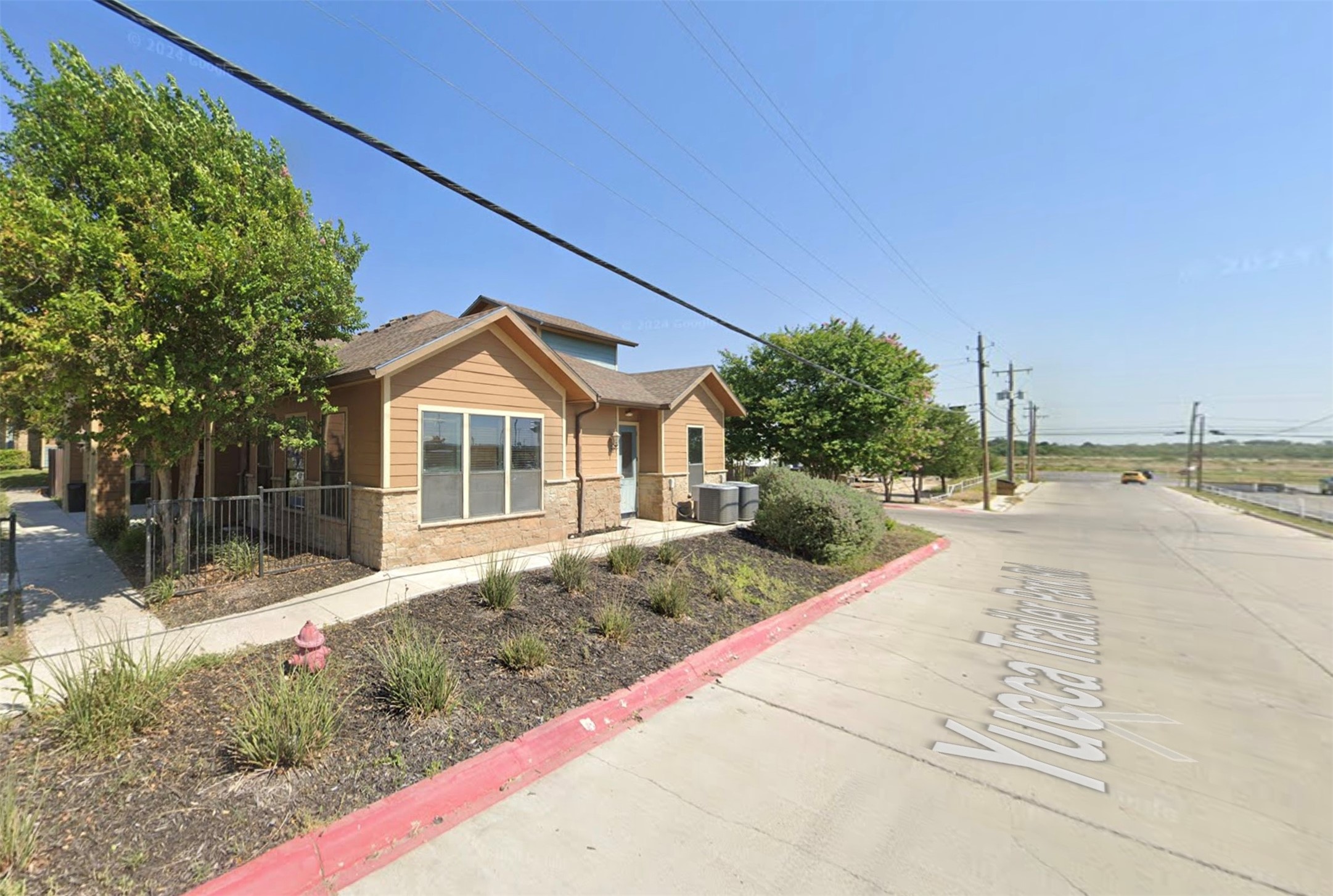 163 Yucca Park Road Del Rio, TX 78840 - Photo 5 of 6 a front view of a house with a yard and potted plants