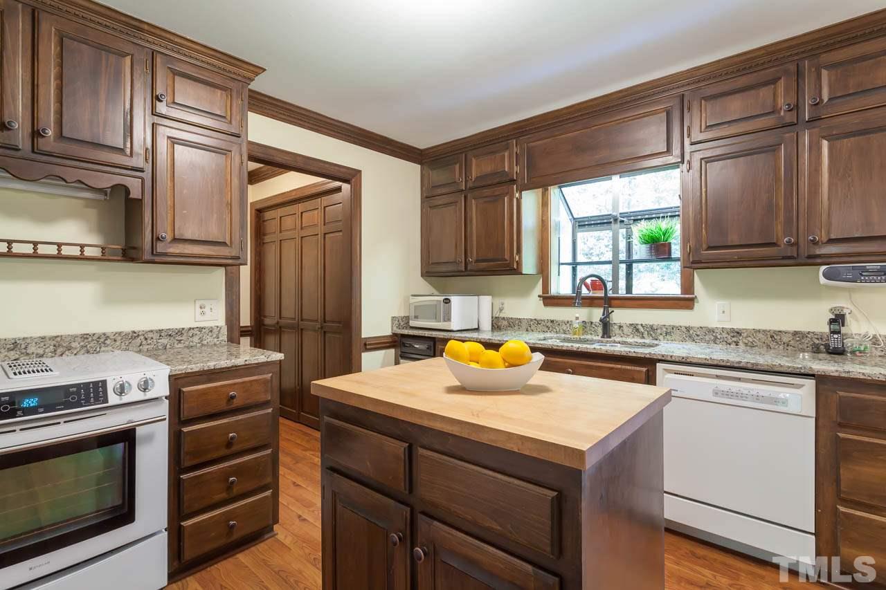 2901 Patrie Place Raleigh, NC 27613 - Photo 11 of 25 a kitchen with a stove a sink and a microwave