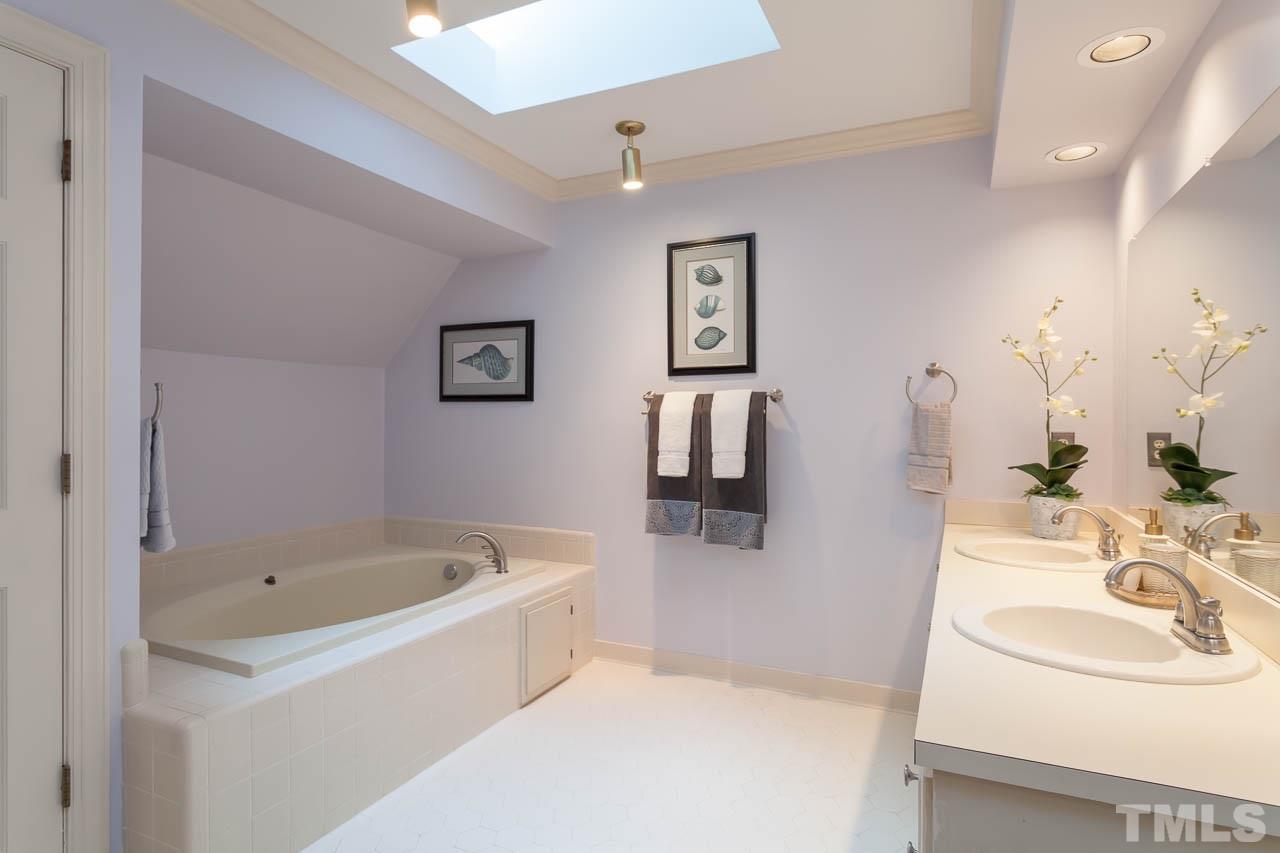 2901 Patrie Place Raleigh, NC 27613 - Photo 15 of 25 a bathroom with a bathtub and a sink