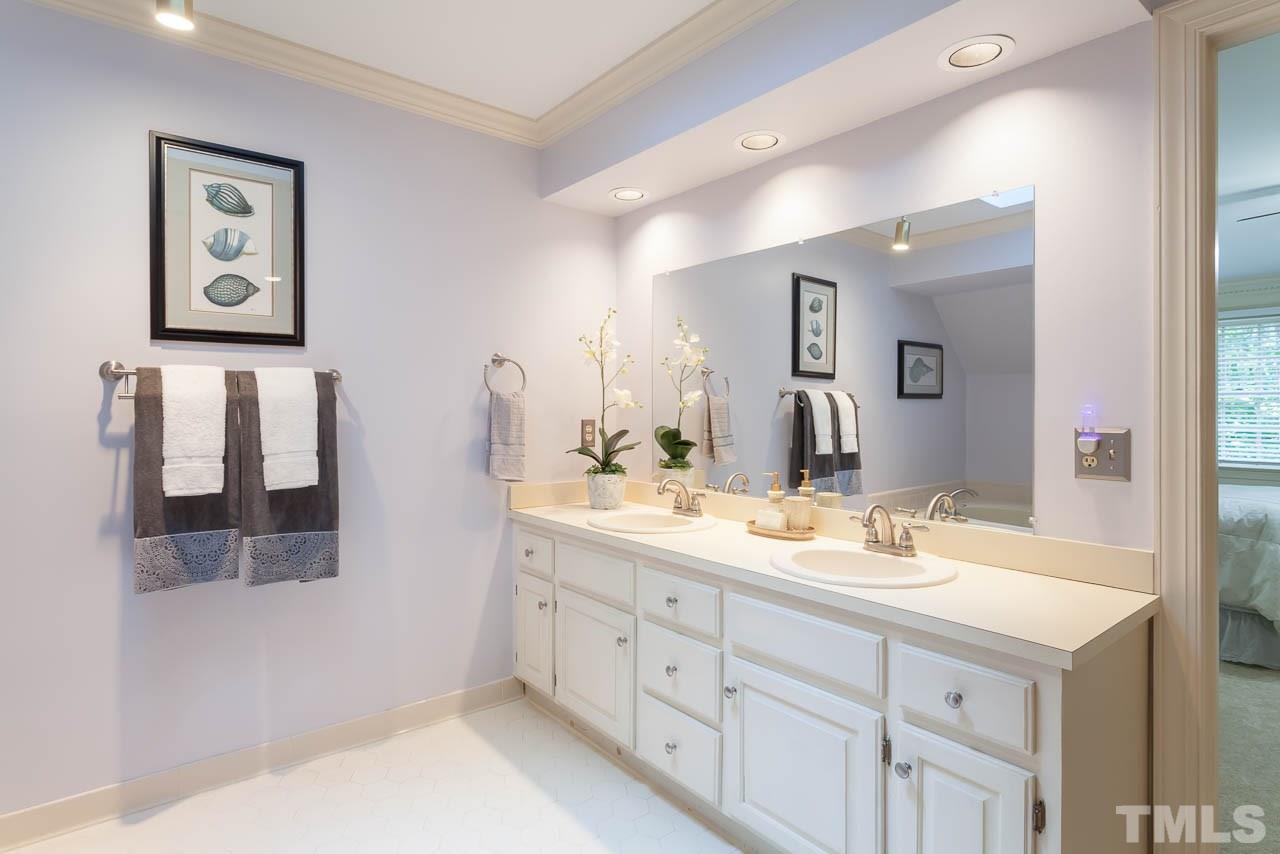 2901 Patrie Place Raleigh, NC 27613 - Photo 16 of 25 a bathroom with a double vanity sink and a mirror